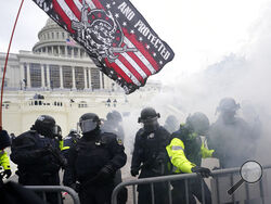 FILE - In this Jan. 6, 2021, file photo police hold off supporters of Donald Trump who tried to break through a police barrier at the Capitol in Washington. House Speaker Nancy Pelosi has told Democratic colleagues that she will create a new committee to investigate the Jan. 6 insurrection at the Capitol. (AP Photo/Julio Cortez, File)