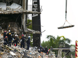 South Florida Urban Search and Rescue team look through rubble for survivors at the partially collapsed Champlain Towers South condo building in Surfside, Florida on Monday, June 28, 2021. As of early morning Monday, 152 people are missing and the death toll has climbed to nine. (Matias J. Ocner/Miami Herald via AP)