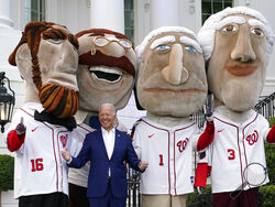 President Joe Biden visits with members of the Washington Nationals' Racing Presidents after speaking at an Independence Day celebration on the South Lawn of the White House, Sunday, July 4, 2021, in Washington. (AP Photo/Patrick Semansky)