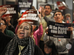 FILE - In this Tuesday, Feb. 17, 2015 file photo, Mercedes Herrera and others chant during an event on DACA and DAPA Immigration Relief at the Houston International Trade Center in Houston. A federal judge in Texas on Friday, July 16, 2021 ordered an end to an Obama-era program that prevented the deportations of some immigrants brought into the United States as children, putting new pressure for action on President Joe Biden and Democrats who now control Congress. (Melissa Phillip/Houston Chronicle via AP, 