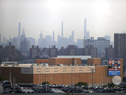 Manhattan is seen from Yankee Stadium through a haze of smoke before a baseball game between the Philadelphia Phillies and the New York Yankees, Wednesday, July 21, 2021, in New York. Wildfires in the American West, including one burning in Oregon that's currently the largest in the U.S., are creating hazy skies as far away as New York as the massive infernos spew smoke and ash into the air in columns up to six miles high. (AP Photo/Adam Hunger)