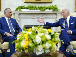President Joe Biden, right, speaks as Iraqi Prime Minister Mustafa al-Kadhimi, left, listens during their meeting in the Oval Office of the White House in Washington, Monday, July 26, 2021. (AP Photo/Susan Walsh)