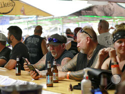 FILE - In this Aug. 7, 2020, file photo, people congregate at One-Eyed Jack's Saloon during the 80th annual Sturgis Motorcycle Rally in Sturgis, S.D. The annual Sturgis Motorcycle Rally refused to take 2020 off despite the threat of the coronavirus pandemic, a decision blamed for leading to a late-summer spike in cases across the Midwest. And it's about to roar right back this year, kicking off Friday, Aug. 6, 2021 with crowds expecting to be significantly larger even as the delta variant is rising. (AP Pho