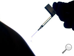FILE - In this Dec. 15, 2020, file photo, a droplet falls from a syringe after a health care worker was injected with the Pfizer-BioNTech COVID-19 vaccine at a hospital in Providence, R.I. Genesis Healthcare, the nation’s largest nursing home operator which has 70,000 employees at nearly 400 nursing homes and senior communities, told its workers this week they will have to get COVID-19 vaccinations to keep their jobs — a possible shift in an industry that has largely rejected compulsory measures for fear of
