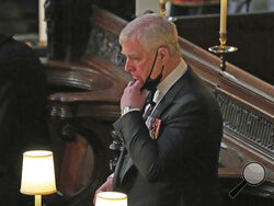 FILE - Britain's Prince Andrew stands inside St. George's Chapel during the funeral of his father, Prince Philip, at Windsor Castle, Windsor, England, Saturday April 17, 2021. Longtime Jeffrey Epstein accuser Virginia Giuffre sued Prince Andrew on Monday, Aug. 9, 2021, saying he sexually assaulted her when she was 17. Lawyers for Giuffre filed the lawsuit in Manhattan federal court. (Yui Mok/Pool via AP, File)