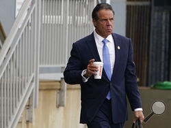 New York Gov. Andrew Cuomo prepares to board a helicopter after announcing his resignation, Tuesday, Aug. 10, 2021, in New York. Cuomo says he will resign over a barrage of sexual harassment allegations. The three-term Democratic governor's decision, which will take effect in two weeks, was announced Tuesday as momentum built in the Legislature to remove him by impeachment. (AP Photo/Seth Wenig)