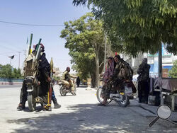 Taliban fighters patrol inside the city of Ghazni, southwest of Kabul, Afghanistan, Thursday, Aug. 12, 2021. The Taliban captured the provincial capital near Kabul on Thursday, the 10th the insurgents have taken over a weeklong blitz across Afghanistan as the U.S. and NATO prepare to withdraw entirely from the country after decades of war. (AP Photo/Gulabuddin Amiri)