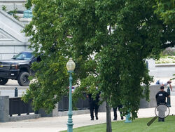 A person is apprehended after being in a pickup truck parked on the sidewalk in front of the Library of Congress' Thomas Jefferson Building, as seen from a window of the U.S. Capitol, Thursday, Aug. 19, 2021, in Washington. Officials evacuated a number of buildings around the Capitol and sent snipers to the area after officers saw a man holding what looked like a detonator inside the pickup, which had no license plates. The man was identified as Floyd Ray Roseberry, 49, of Grover, North Carolina, according 