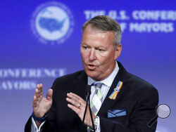 FILE - In this June 26, 2016, file photo, Orlando Mayor Buddy Dyer addresses the the U.S. Conference of Mayors in Indianapolis. Dyer on Friday, Aug. 2021, asked residents to stop watering their lawns and washing their cars for a least a week, saying water usage needed to be cut back because of the recent surge of COVID-19 hospitalizations. The Orlando Utility Commission treats the city's water with liquid oxygen and supplies that ordinarily go toward water treatment have been diverted to hospitals for patie
