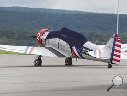 One of the T-6 Texan plane that is part of the GEICO Skytypers team scheduled to perform at the Great Pocono Raceway Airshow, is parked at the Wilkes-Barre Scranton International Airport Friday, Aug. 20, 2021 in Avoca, Pa. A small plane that was due to take part in an upcoming air show crashed shortly after takeoff at an airport in eastern Pennsylvania, killing the pilot. Authorities say the crash at the Wilkes-Barre/Scranton International Airport occurred around 12:35 p.m. Friday. (Mark Moran/The Citizens'