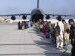 In this image provided by the U.S. Air Force, U.S. Air Force loadmasters and pilots assigned to the 816th Expeditionary Airlift Squadron, load people being evacuated from Afghanistan onto a U.S. Air Force C-17 Globemaster III at Hamid Karzai International Airport in Kabul, Afghanistan, Tuesday, Aug. 24, 2021. (Master Sgt. Donald R. Allen/U.S. Air Force via AP)