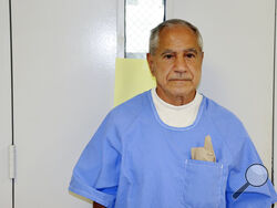In this image provided by the California Department of Corrections and Rehabilitation, Sirhan Sirhan arrives for a parole hearing Friday, Aug. 27, 2021, in San Diego. Sirhan faces his 16th parole hearing Friday for fatally shooting U.S. Sen. Robert F. Kennedy in 1968. (California Department of Corrections and Rehabilitation via AP)