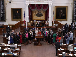 FILE - In this May 5, 2021, file photo, Texas state Rep. Donna Howard, D-Austin, center at lectern, stands with fellow lawmakers in the House Chamber in Austin, Texas, as she opposes a bill introduced that would ban abortions as early as six weeks and allow private citizens to enforce it through civil lawsuits, under a measure given preliminary approval by the Republican-dominated House. A Texas law banning most abortions in the state took effect at midnight on Sept. 1 but the Supreme Court has yet to act o