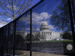 FILE - In this April 2, 2021, file photo, the U.S. Capitol is seen behind security fencing on Capitol Hill in Washington. Law enforcement concerned by the prospect for violence at a rally in the nation’s Capitol next week are planning to reinstall protective fencing that surrounded the U.S. Capitol for months after the Jan. 6 insurrection there, according to a person familiar with the discussions. (AP Photo/Carolyn Kaster, File)