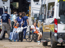 Paramedics evacuate people at a mass shelter Thursday, Sep.t 2, 2021 in Independence, La. Multiple nursing home residents died after Hurricane Ida, but full details of their deaths are unknown because state health inspectors said Thursday that they were turned away from examining conditions at the facility to which they had been evacuated. (Chris Granger/The Times-Picayune/The New Orleans Advocate via AP)