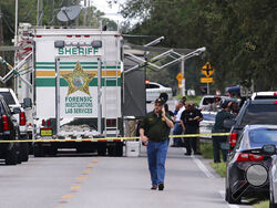 Polk County, Fla., Sheriff's officials work the scene of a multiple fatality shooting Sunday, Sept. 5, 2021, in Lakeland, Fla. Four people are dead including a mother who was still cradling her now deceased baby in what Florida sheriff's deputies are calling a massive gun battle with a suspect. (Michael Wilson/The Ledger via AP)
