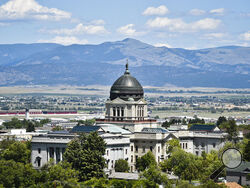 FILE - This July 2020 file photo shows the Montana State Capitol in Helena, Mont. Amid the coronavirus pandemic, Montana's legislature passed restrictive laws severely curbing quarantine and isolation powers, increasing local officials' power over local health boards, preventing limits on religious gatherings, and banning employers — including in health care settings — from requiring vaccinations for COVID, the flu or anything else. (Thom Bridge/Independent Record via AP, File)