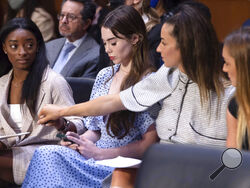 United States gymnasts from left, Simone Biles, McKayla Maroney, Aly Raisman and Maggie Nichols, arrive to testify during a Senate Judiciary hearing about the Inspector General's report on the FBI's handling of the Larry Nassar investigation on Capitol Hill, Wednesday, Sept. 15, 2021, in Washington. Nassar was charged in 2016 with federal child pornography offenses and sexual abuse charges in Michigan. He is now serving decades in prison after hundreds of girls and women said he sexually abused them under t