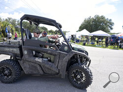 Florida Fish and Wildlife Commission officers ride past media stationed at the entrance of the Carlton Reserve during a search for Brian Laundrie, Tuesday, Sept. 21, 2021, in Venice, Fla. Laundrie is a person of interest in the disappearance of his girlfriend, Gabrielle "Gabby" Petito. (AP Photo/Phelan M. Ebenhack)