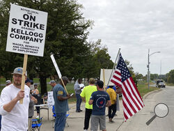 Workers from a Kellogg's cereal plant picket along the main rail lines leading into the facility on Wednesday, Oct. 6, 2021, in Omaha, Neb. Workers have gone on strike after a breakdown in contract talks with company management. (AP Photo/Grant Schulte).
