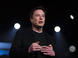FILE - In this March 14, 2019, file photo, Tesla CEO Elon Musk speaks before unveiling the Model Y at the company's design studio in Hawthorne, Calif. Tesla says it will relocate its headquarters from Palo Alto, Calif., to Austin, Texas, though the electric car maker will keep expanding its manufacturing capacity in the Golden State. Musk gave no timeline for the move late Thursday, Oct. 7, 2021, when he addressed the company's shareholders at Tesla's annual meeting. (AP Photo/Jae C. Hong, File)