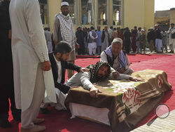 Relatives and residents attend a funeral ceremony for victims of a suicide attack at the Gozar-e-Sayed Abad Mosque in Kunduz, northern Afghanistan, Saturday, Oct. 9, 2021. The mosque was packed with Shiite Muslim worshippers when an Islamic State suicide bomber attacked during Friday prayers, killing dozens in the latest security challenge to the Taliban as they transition from insurgency to governance. (AP Photo/Abdullah Sahil)