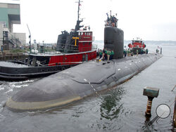 FILE - In this Friday, July 30, 2004 file photo, the U.S.S. Virginia returns to the Electric Boat Shipyard in Groton Conn., after its first sea trials. A Navy nuclear engineer with access to military secrets has been charged with trying to pass information about the design of American nuclear-powered submarines to someone he thought was a representative of a foreign government but who turned out to be an undercover FBI agent, the Justice Department said Sunday, Oct. 10, 2021. (AP Photo/Jack Sauer, File)