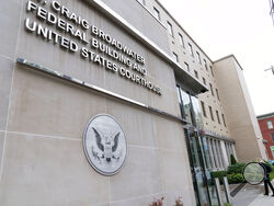 People enter to the U.S. District Courthouse were Jonathan and Diana Toebbe have their hearing in Martinsburg, W.Va., on Tuesday, Oct. 12, 2021. Jonathan Toebbe, a Navy nuclear engineer, has been charged with trying to pass information about the design of American nuclear-powered submarines to someone he thought was a representative of a foreign government but who turned out to be an undercover FBI agent. His wife also was arrested. (AP Photo/Jose Luis Magana)