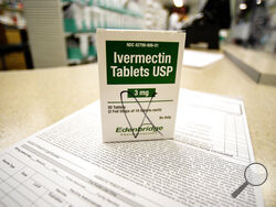 A box of ivermectin is shown in a pharmacy as pharmacists work in the background, Thursday, Sept. 9, 2021, in Ga. At least two dozen lawsuits have been filed around the U.S., many in recent weeks by people seeking to force hospitals to give their COVID-stricken loved ones ivermectin, a drug for parasites that has been promoted by conservative commentators as a treatment despite a lack of conclusive evidence that it helps people with the virus. (AP Photo/Mike Stewart)