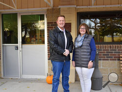 Ken and Kelly Speidel stand outside the community hall of Cascade, Mont., Friday, Oct. 15, 2021. The Speidels own a horse boarding business in Cascade, a rural community on the banks of the Missouri River. For the first time in 30 years, the Census has awarded Montana a second seat in Congress and a commission is being tasked with determining how to divide the state into two congressional districts. (AP Photo/Iris Samuels)