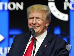 FILE - In this July 24, 2021, file photo, former President Donald Trump smiles as he pauses while speaking to supporters at a Turning Point Action gathering in Phoenix. Trump's social media company will be getting tens of millions in special bonus shares in a new publicly traded entity if it performs well, handing the ex-president possibly billions of dollars in paper wealth based on current stock prices, according to a prospectus filed with security regulators on Tuesday, Oct. 26, 2021. (AP Photo/Ross D. F