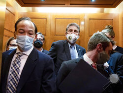 Sen. Joe Manchin, D-W.Va., center, and Sen. Kyrsten Sinema, D-Ariz., far left, board an elevator as they leave a meeting, Wednesday, Oct. 27, 2021, on Capitol Hill in Washington. (AP Photo/Jacquelyn Martin)