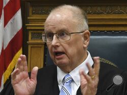 Judge Bruce Schroeder talks about the juror who attempted to tell a joke to a bailiff during Kyle Rittenhouse's trial at the Kenosha County Courthouse in Kenosha, Wis., on Thursday, Nov. 4, 2021. The juror, known as Juror No. 7, was removed due to the incident. Rittenhouse is accused of killing two people and wounding a third during a protest over police brutality in Kenosha, last year. (Mark Hertzberg /Pool Photo via AP)