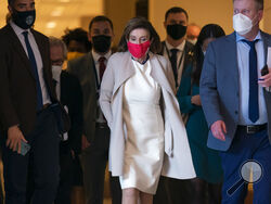 Speaker of the House Nancy Pelosi, D-Calif., returns to her office after meeting with reporters as the House prepares to debate and vote on a revised draft of President Joe Biden's now-$1.85 trillion domestic policy package as well as a companion $1 trillion infrastructure bill, at the Capitol in Washington, Thursday, Nov. 4, 2021. (AP Photo/J. Scott Applewhite)