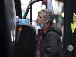 A person takes COVID-19 test at mobile testing site near Grand Central Terminal on Friday, Dec. 3, 2021, in New York. The omicron variant of COVID-19, which had been undetected in the U.S. before the middle of this week, had been discovered in at least five states by the end of Thursday, showing yet again how mutations of the virus can circumnavigate the globe with speed and ease.(AP Photo/Yuki Iwamura)