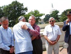 FILE - Edward Shames, center, hugs Ed McClung, center left, both members of the World War II Army Company E of the 506th Regiment of the 101st Airborne, with veterans Jack Foley, left, Joe Lesniewski, right, and Shifty Powers, far right, at the Library of Congress in Washington, on July 16, 2003. Shames, who was the last surviving officer of “Easy Company,” which inspired the HBO miniseries and book “Band of Brothers,” has died at age 99. An obituary posted by the Holomon-Brown Funeral Home & Crematory said