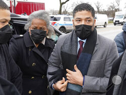 Actor Jussie Smollett arrives Monday, Dec. 6, 2021, with his mother Janet at the Leighton Criminal Courthouse for day five of his trial in Chicago. Smollett is accused of lying to police when he reported he was the victim of a racist, anti-gay attack in downtown Chicago nearly three years ago, in Chicago. (AP Photo/Charles Rex Arbogast)