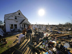 Volunteers, mostly employees from the Mayfield Consumer Products factory, help salvage possessions from the destroyed home of Martha Thomas, in the aftermath of tornadoes that tore through the region several days earlier, in Mayfield, Ky., Monday, Dec. 13, 2021. (AP Photo/Gerald Herbert)