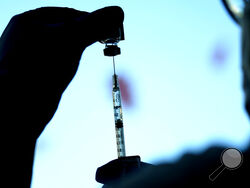FILE - A dose of a Pfizer COVID-19 vaccine is prepared at Lurie Children's hospital, Nov. 5, 2021, in Chicago. The omicron-fueled surge that is sending COVID-19 cases rocketing in the U.S. is putting children in the hospital in close to record numbers, and experts lament that most of the youngsters are not vaccinated. (AP Photo/Nam Y. Huh, File)