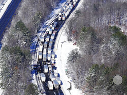 Drivers wait for the traffic to be cleared as cars and trucks are stranded on sections of Interstate 95 Tuesday Jan. 4, 2022, in Carmel Church, Va. Close to 48 miles of the Interstate was closed due to ice and snow. (AP Photo/Steve Helber)
