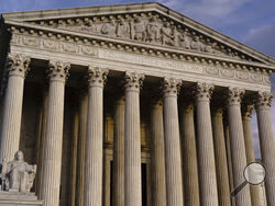 FILE - The Supreme Court is seen at dusk in Washington, Oct. 22, 2021. The Supreme Court will hear oral arguments Jan. 7, 2022, on challenges to whether the Biden administration can order millions of workers at private companies and health care employees be vaccinated for COVID-19. Until the court rules, millions of workers face a patchwork of requirements depending on where they live. (AP Photo/J. Scott Applewhite, File)