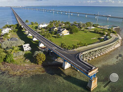 This Monday, Jan. 10, 2022, drone aerial photo provided by the Florida Keys News Bureau shows the Old Seven Mile Bridge ready for its Wednesday, Jan. 12, 2022, reopening to pedestrians, bicyclists, anglers and visitors to Pigeon Key (island shown in photo). The old bridge originally was part of Henry Flagler's Florida Keys Over-Sea Railroad that was completed in 1912. The railroad ceased operations in 1935 and was converted into a highway that opened in 1938. In 1982, construction was completed on a new Sev