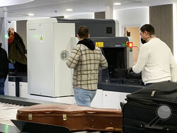 Passengers walk next to Nuctech security scanners at the Brussels Eurostar train terminal on Monday, Jan. 17, 2022. A growing number of Western security officials and policymakers fear that China could exploit Nuctech equipment to sabotage key transit points or get illicit access to government, industrial or personal data from the items that pass through its devices. Nuctech dismisses those concerns, countering that its European operations comply with local laws, including strict security checks and data pr