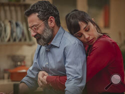 This photo released by Netflix shows characters from the Arabic-language version of the Italian film “Perfect Strangers,” about friends who agree to share their incoming calls, voice and text messages with each other over a dinner party, leading to a series of revelations that test their marriages and friendships. The film’s release has led to a widespread debate in some Arabic-speaking societies, such as Egypt, where some have denounced it as a threat to family and religious values while others praised and