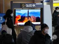 People watch a TV showing an image of North Korea's missile launch during a news program at the Seoul Railway Station in Seoul, South Korea, Monday, Jan. 31, 2022. North Korea confirmed Monday it test-launched an intermediate-range ballistic missile capable of reaching the U.S. territory of Guam, the North's most significant weapon launch in years, as Washington plans to respond to demonstrate it's committed to its allies' security in the region. (AP Photo/Ahn Young-joon)