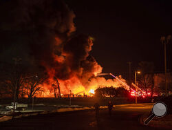 A structure fire burns at the Weaver Fertilizer Plant on Monday, Jan. 31, 2022, in Winston-Salem, N.C. (Allison Lee Isley/The Winston-Salem Journal via AP)