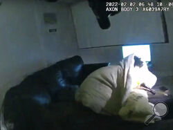 In this image taken from Minneapolis Police Department body camera video and released by the city of Minneapolis, 22-year-old Amir Locke wrapped in a blanket on a couch holding a gun moments before he was fatally shot by Minneapolis police as they were executing a search warrant in a homicide investigation on Wednesday, Feb. 2, 2022, in Minneapolis. Authorities have not said if Locke was connected to the homicide investigation or named in the warrant. (Minneapolis Police Department via AP)