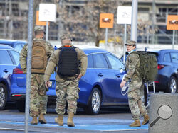 U.S. Army officers after arrival at the Rzeszow-Jasionka airport in southeastern Poland, on Saturday, Feb. 5, 2022, coming from Wiesbaden, Germany where a U.S. Army administration garrison is based. Additional U.S. troops are arriving in Poland after President Joe Biden ordered the deployment of 1,700 soldiers here amid fears of a Russian invasion of Ukraine. Some 4,000 U.S. troops have been stationed in Poland since 2017. (AP Photo/Czarek Sokolowski)