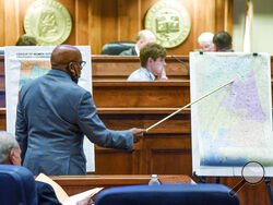 FILE - Sen. Rodger Smitherman compares U.S. Representative district maps during the special session on redistricting at the Alabama Statehouse in Montgomery, Ala., on Nov. 3, 2021. The Supreme Court has put on hold a lower court ruling that Alabama must draw new congressional districts before the 2022 elections, boosting Republican chances to hold six of the state’s seven seats in the House of Representatives. (Mickey Welsh/The Montgomery Advertiser via AP, File)