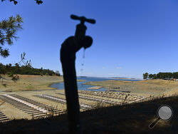 FILE - Water drips from a faucet near boat docks sitting on dry land at the Browns Ravine Cove area of drought-stricken Folsom Lake in Folsom, Calif., on May 22, 2021. The American West's megadrought deepened so much last year that it is now the driest it has been in at least 1200 years and a worst-case scenario playing out live, a new study finds. (AP Photo/Josh Edelson, File)